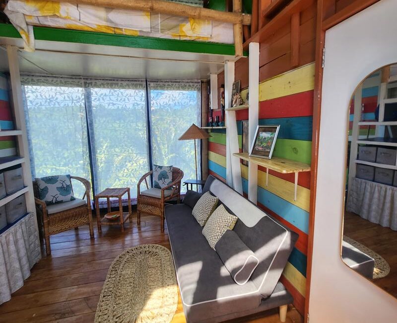 downstairs of one of the lofts with a sitting room, view of the colorful stairs
