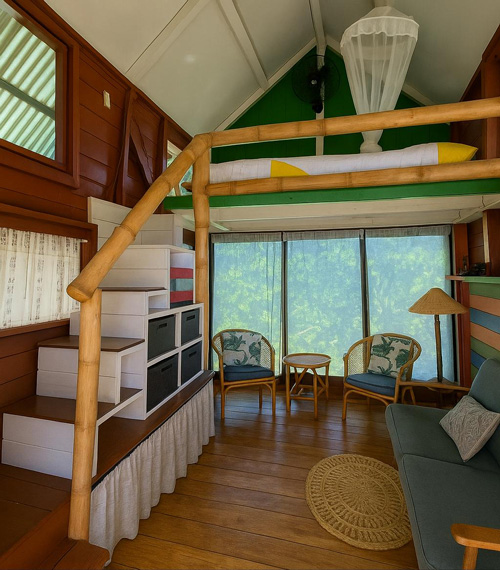 downstairs of one of the lofts with a sitting room, view of the colorful stairs